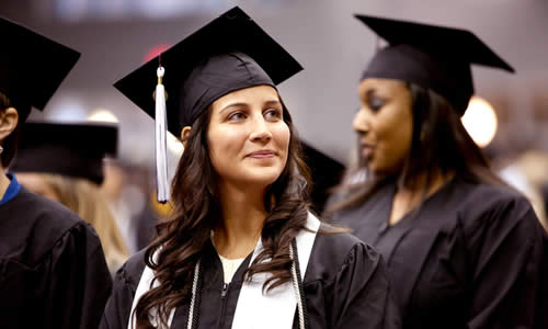 photo of a TWU student in cap and gown during the graduation ceremony