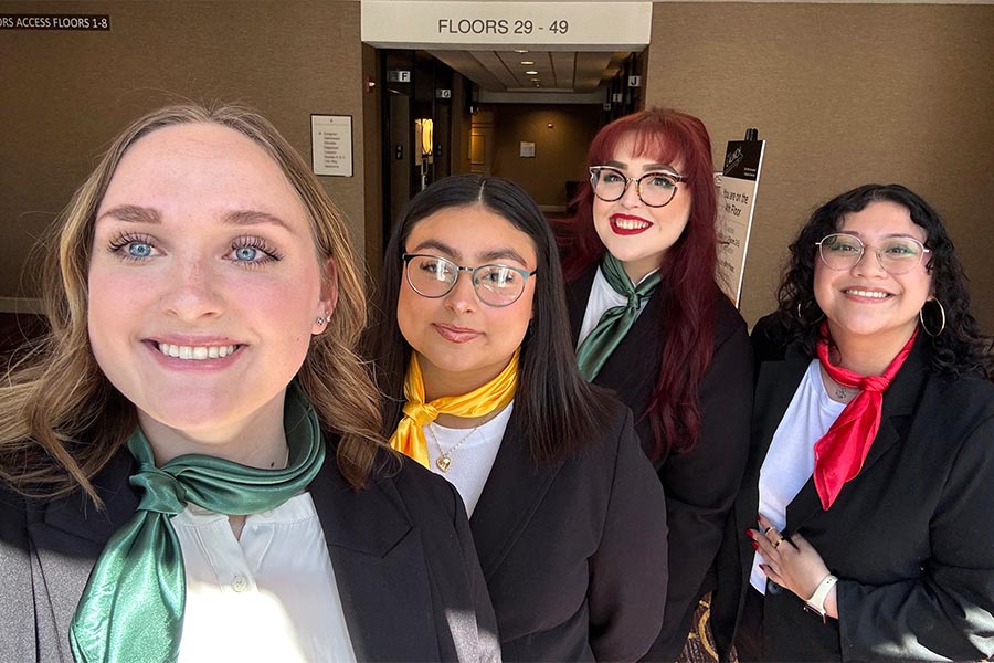four young women in students pose in a selfie photo