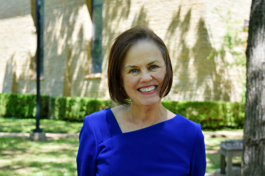 Cheryl Bridges smiling and standing in front of the Little Chapel.