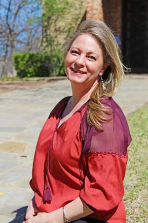 Occupational Therapy student Jessica O'Brien sits near the Little Chapel on the Denton Campus.	