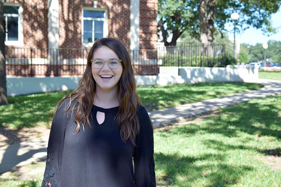 Lindsay Allen smiles near Stoddard Hall.