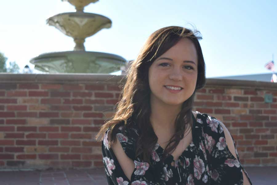 Miranda Moore sits in front of the TWU fountain.