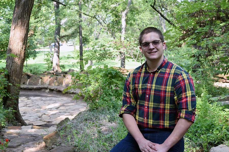 Spencer Williamson sits in the TWU gardens.