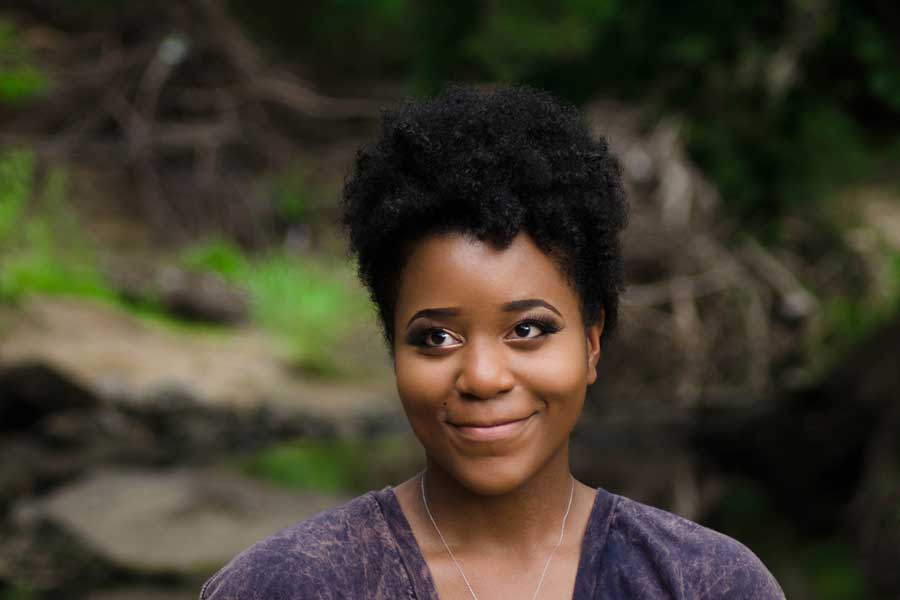 A portrait of Nitasha Johnson in an outdoors setting.