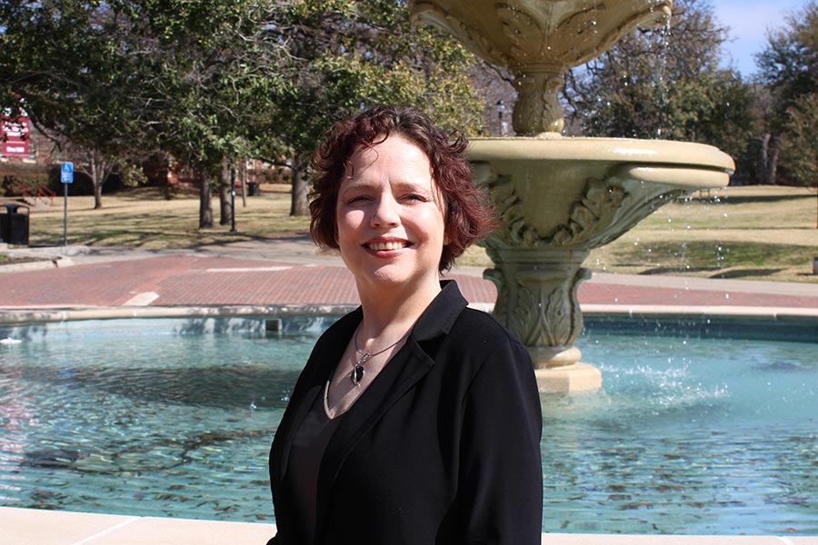 Charity Broomfield in black attire in front of TWU fountain
