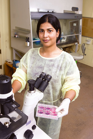 A TWU medical laboratory sciences student looking through a microscope