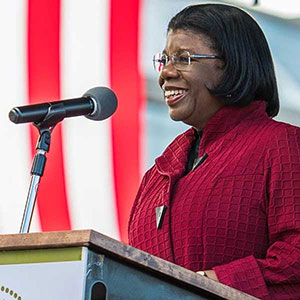 Distinguished Alumna Major General Mary Saunders, USAF (Ret.) speaks at a podium