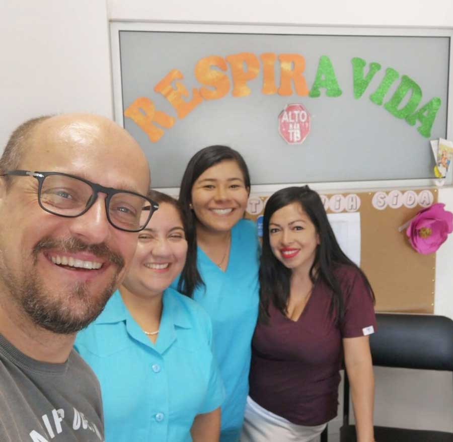 Juan Leyva smiles and poses with research colleagues in Peru.