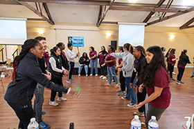 TWU LeaderShape students play an egg-toss style game