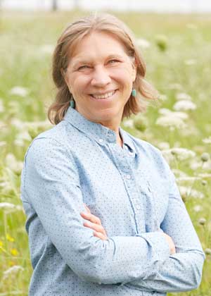 A portrait of Angela McCall smiling outdoors.