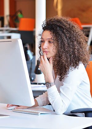 A BBA in Finance student working at her computer.