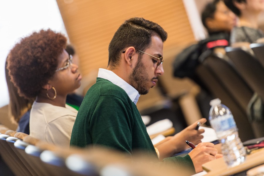 A classroom of students with a man and woman as the main focus.