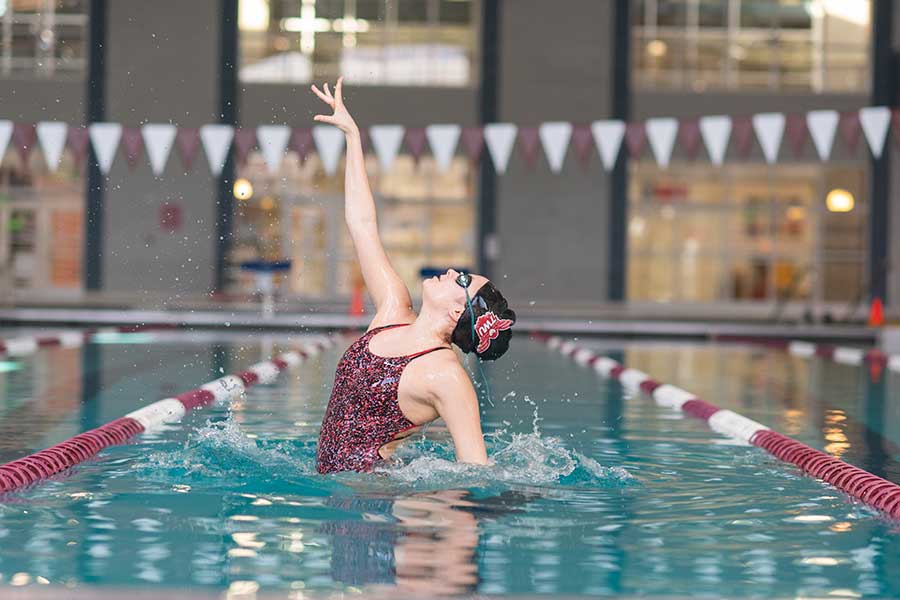 A synchronized swimmer in the on campus pool.