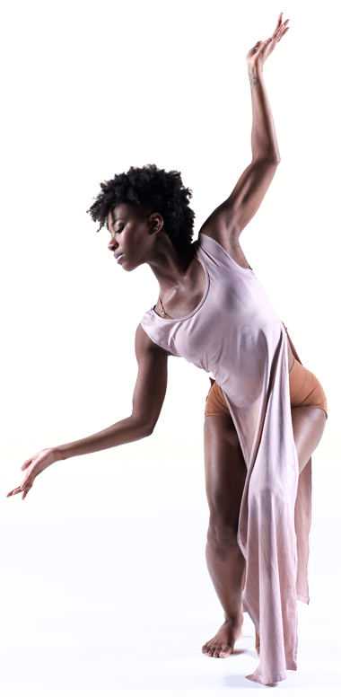 Photo of a female dancer in elegant pose with arms outstretched