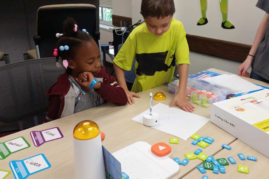 Two DHH students work together to program the Matatalab robot to draw pictures