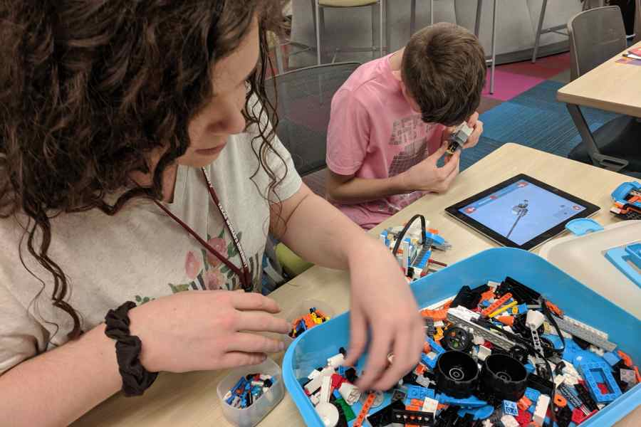 A Camp CoDE counselor and a DHH student build a LEGO robot