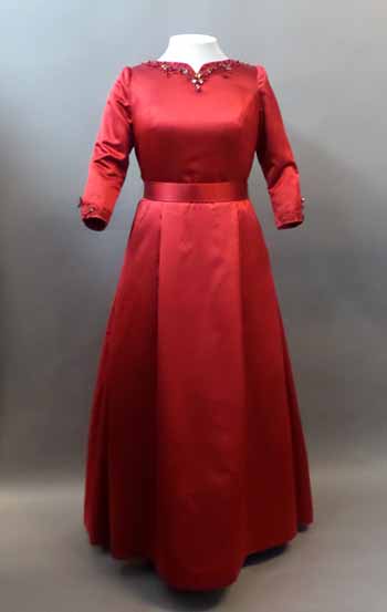 A scarlet red gown with a fitted bodice and crystal embellishments along the neckline.