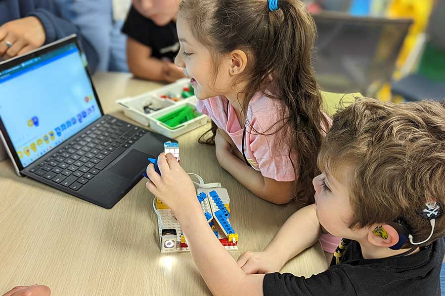 Campers coding a LEGO kit.