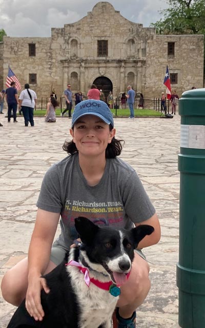 Cecily Zander and her dog at the Alamo