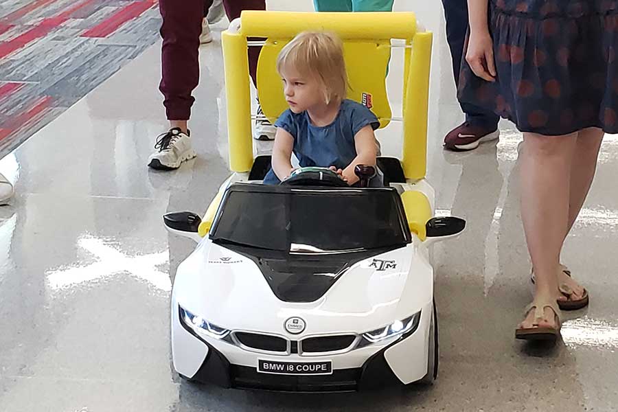 young child drives a small robotic car
