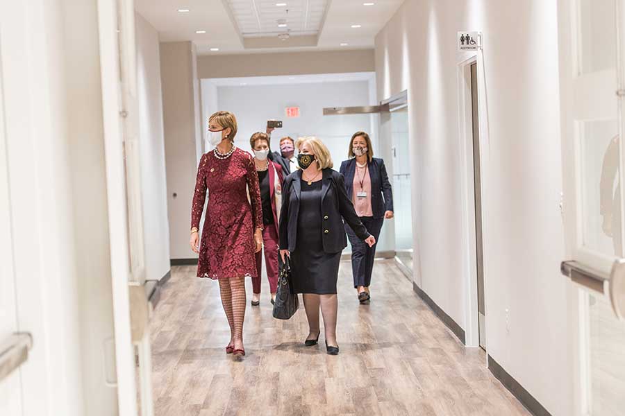 Chancellor Feyten, Sue Bancroft, Jane Nelson and Mary Anna Alhadef walk the halls of the new institute exhibit.