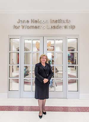 Jane Nelson poses at the front of the Jane Nelson Institute for Women's Leadership.
