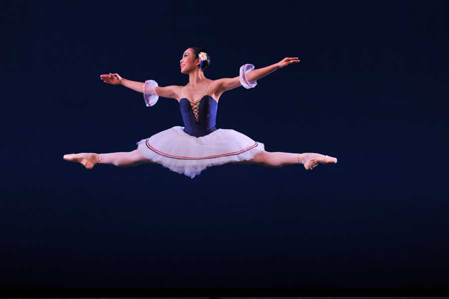 Natsuko Oshima mid-jump during a ballet performance.