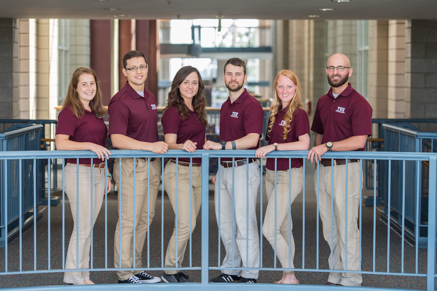 Six TWU students wearing maroon shirts