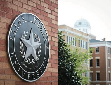 TWU Seal on a brick wall.