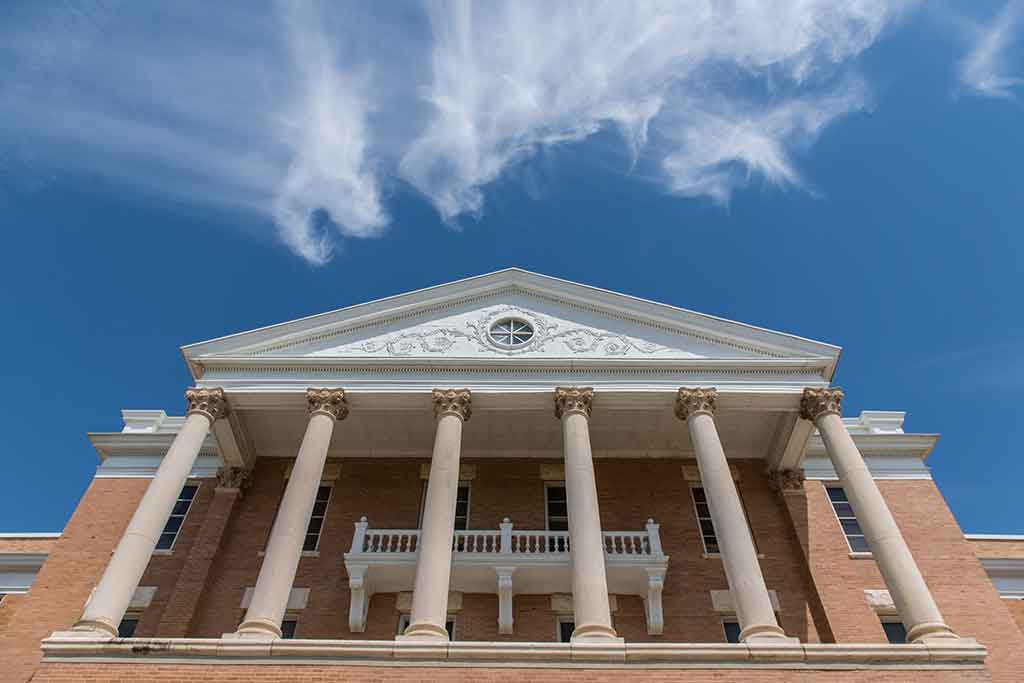 A view of Old Main with clouds in the background.