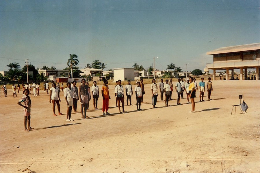 Agueda Gomes teaches a seventh-grade class outdoors in Africa.	