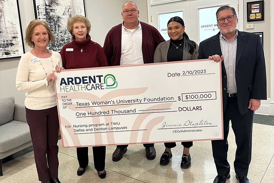 Ardent Health employees hold a $100k check to TWU.