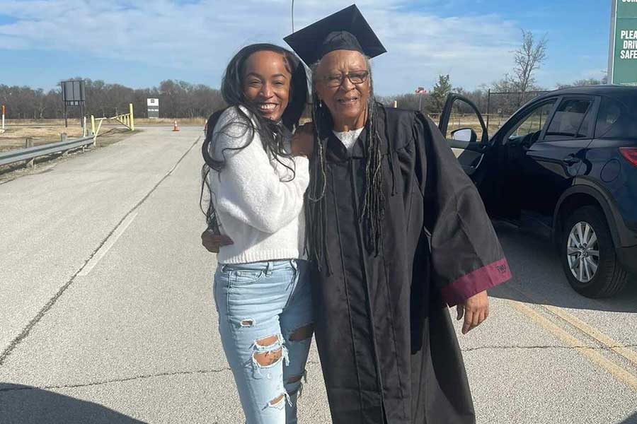 Edna Rawson with a family member in TWU academic regalia at the Texas Motor Speedway.