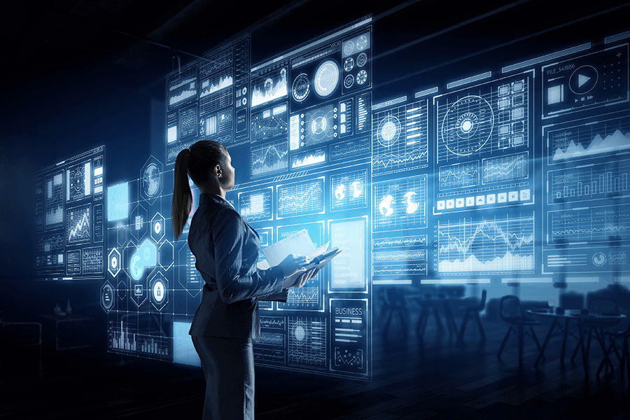 A woman stands in front of a wall of data.