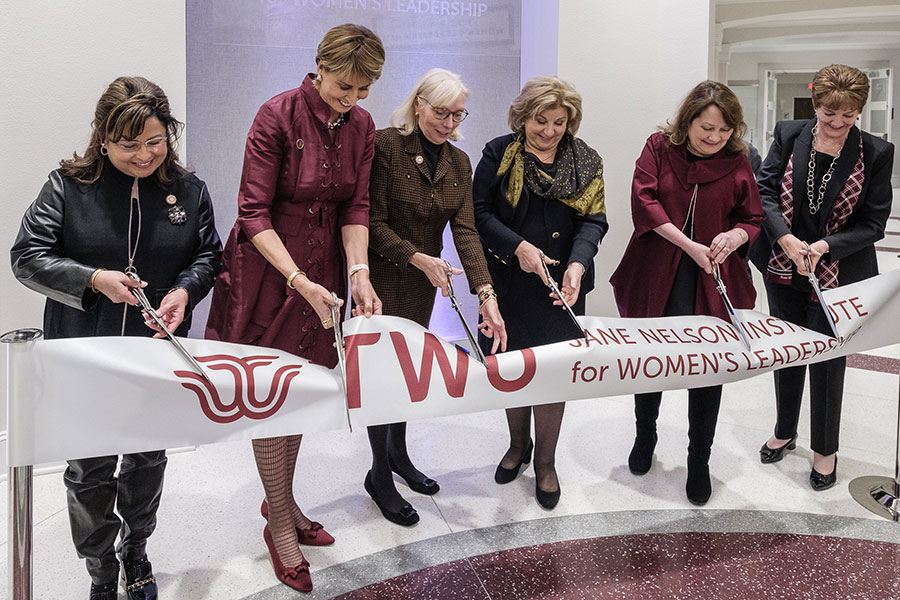 Chancellor Feyten, Senator Jane Nelson and Sue Bancroft cut a ribbon at the Jane Nelson Institute for Women's Leadership lobby.