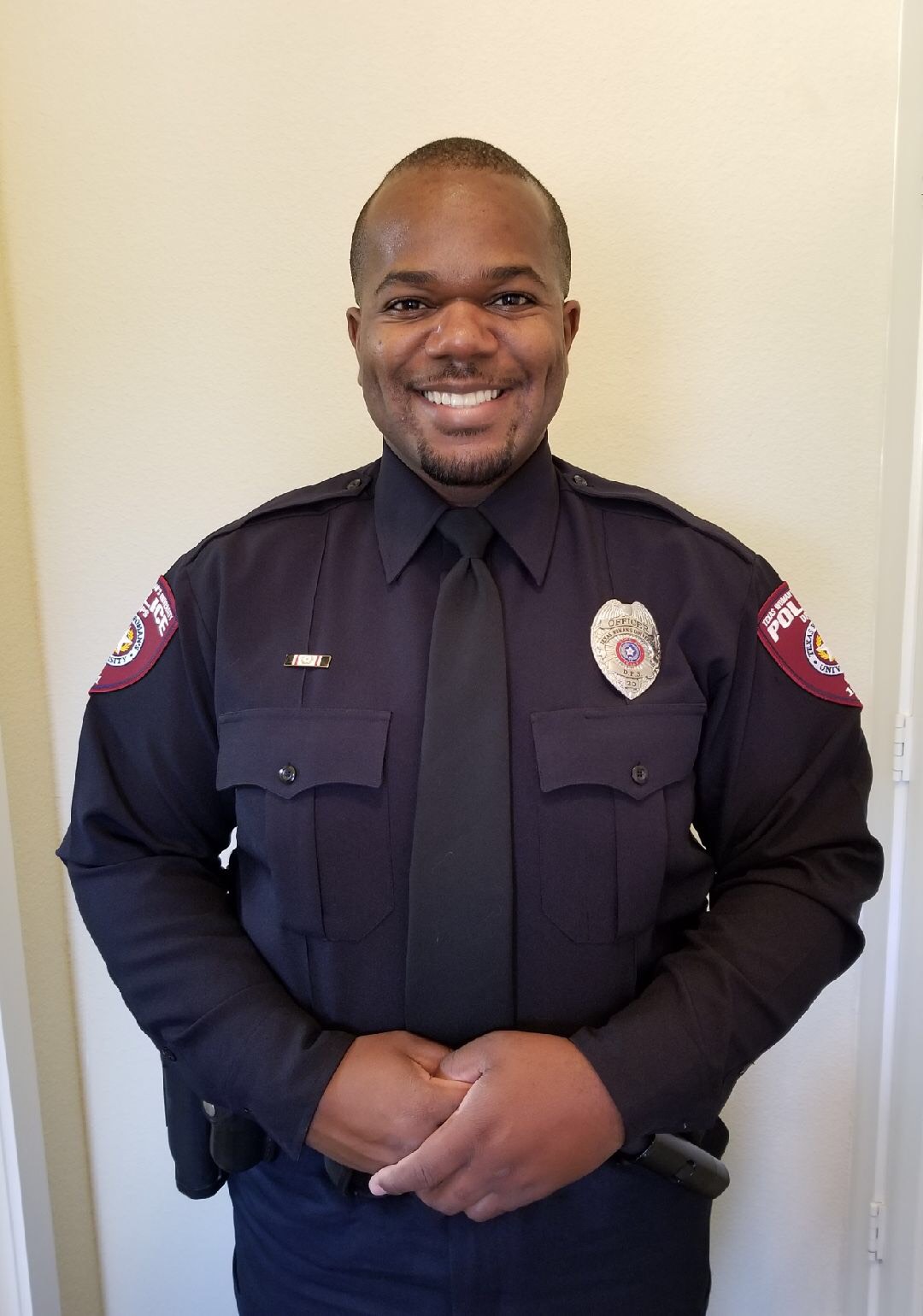 Smiling police office officer in uniform