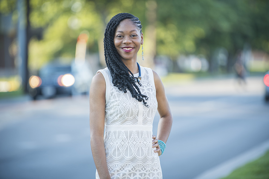 Kamica King wearing white dress at graduation