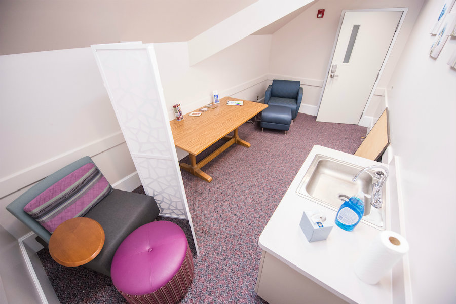 Room with chairs and a sink for use by breastfeeding mothers.