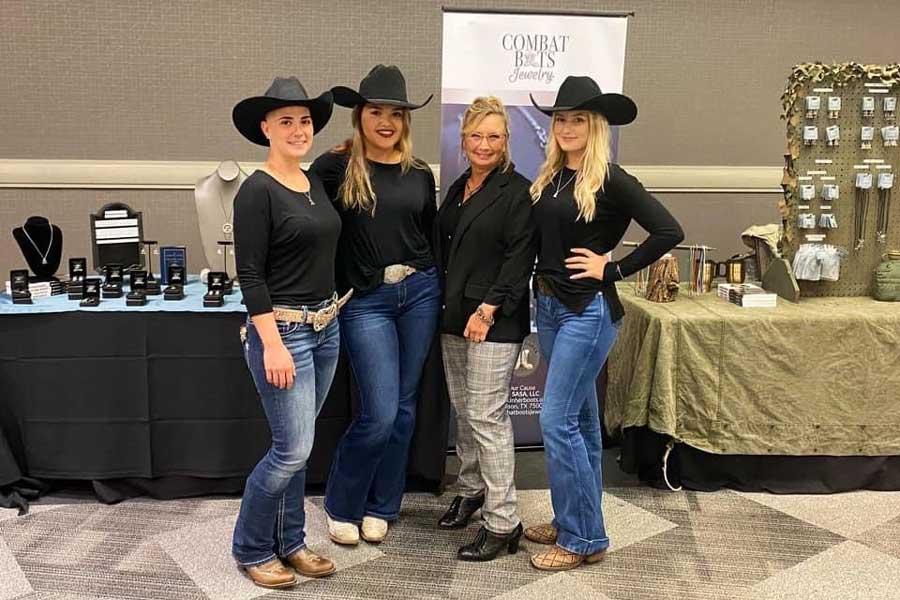 Lisa Bass and her employees work a booth for her jewelry business.