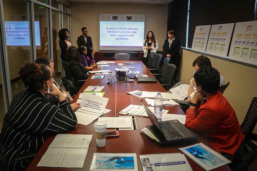 TWU MBA students give a presentation in board room to Parkland hospital executives.