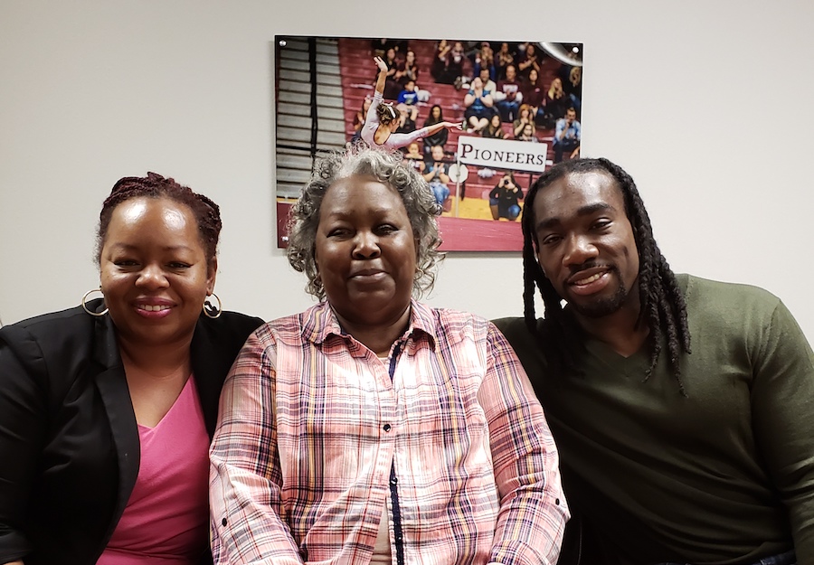 Matthews, his mother, Pauline Matthews, and his sister, Monique Coleman, smile in an office setting.