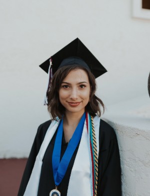 A headshot of Morgan Villavaso in a graduation cap and gown.