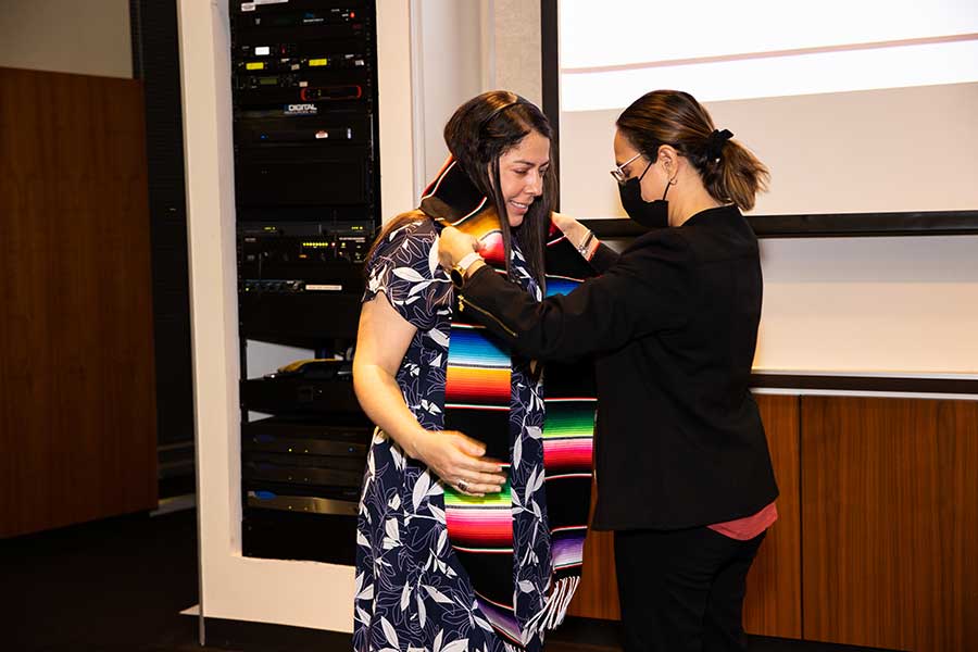 TWU Houston student receives a serape sash.