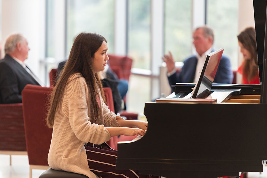 Celia Nowlin plays the piano at the Student Union at Hubbard Hall.