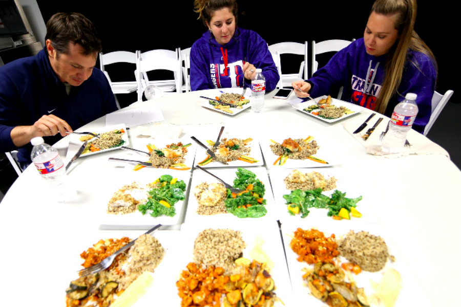 Stephanie Fernandes (Lead RD) and Lindsay Oar sitting at a table judging a Chopped competition.