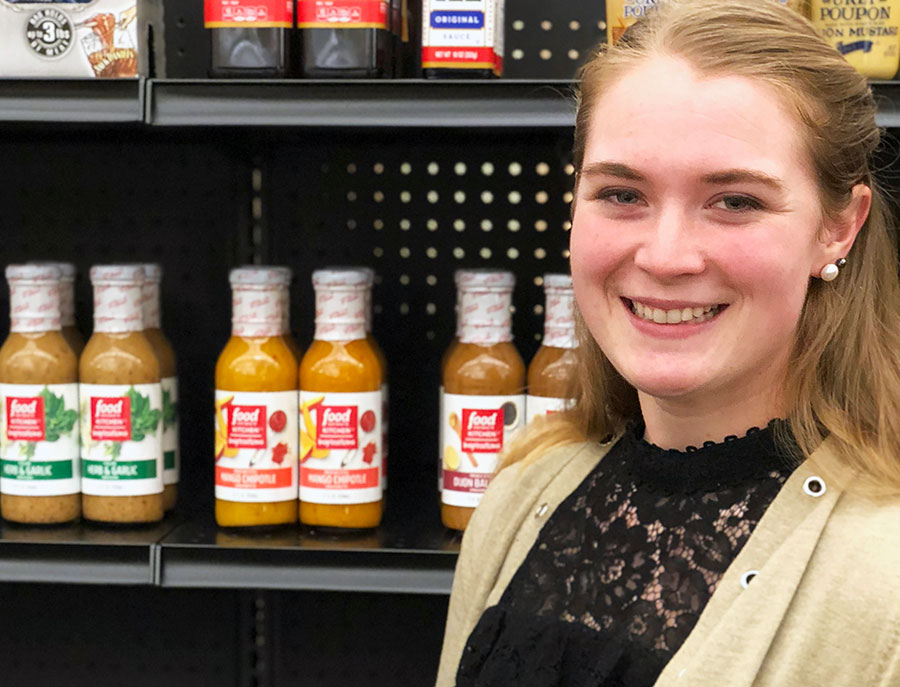 Rachel Russell in front of products