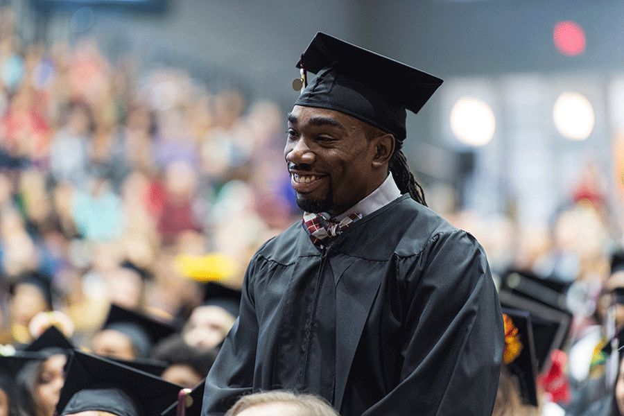 Ryan Matthews in academic regalia at his commencement ceremony on TWU's Denton campus.