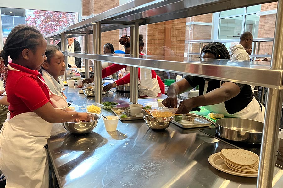 families work on preparing food in community kitchen