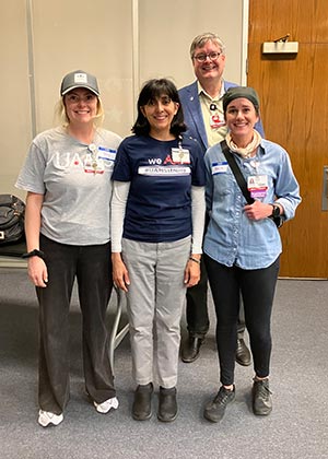 Stephanie Lopez-Neyman, wearing a blue shirt, stands with three of her colleagues