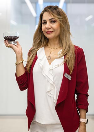 profile picture of Mandana Pahlavani holding a cup of red wine pomace